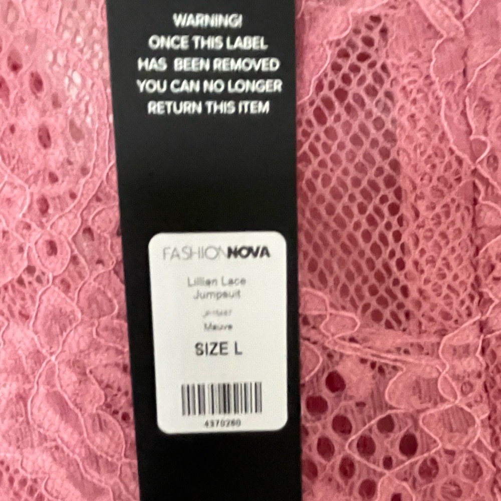 Pink long sleeve lace zip up tie waist jumpsuit.